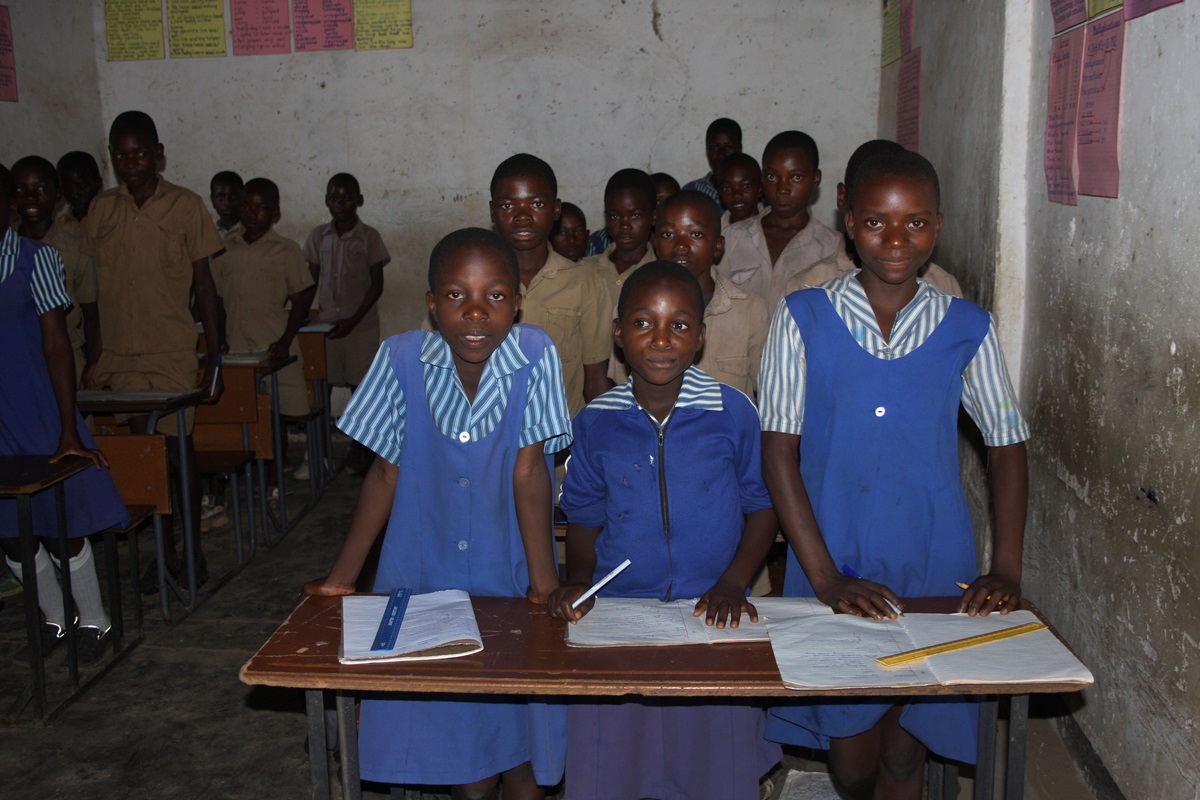 Students now studying in what was once a cooling room for vegetables on a commercial farm are looking forward to the classrooms at the new Saungweme Primary  School.  Photo by Vicki Brown, UMNS