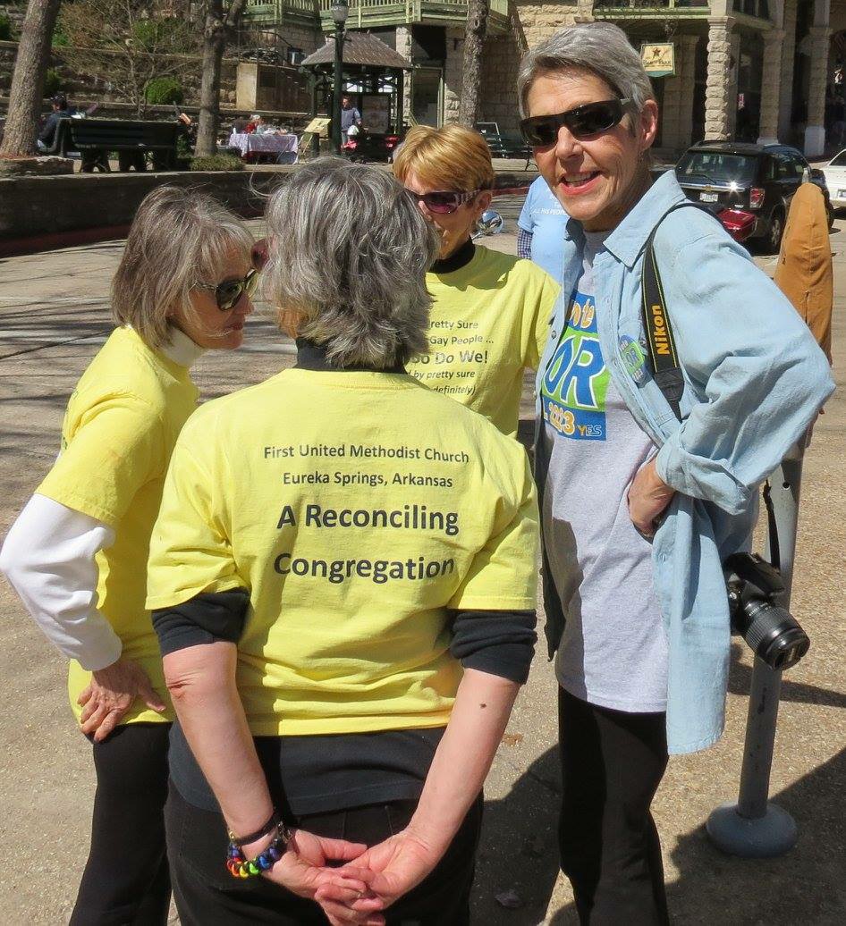 Members of First United Methodist Church Stryker talk with Sandy Martin, a resident of Eureka Springs, Ark., who came to the Jesus Parade. From left, Suzie Bell, Peggy Way and Kim Stryker.