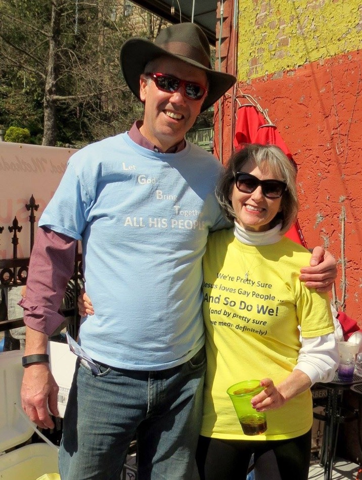 Dr. Dan Bell and Suzie Bell stand in front of an outdoor patio of restaurant New Delhi where the group set up their table.