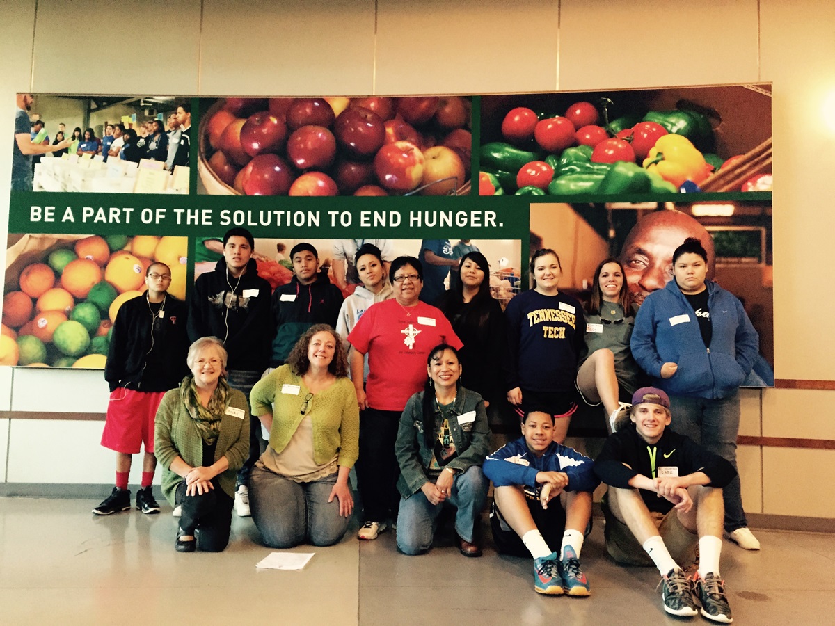 Youth from Clinton Indian United Methodist Church and Community Center in Oklahoma and Providence United Methodist Church, Mount Juliet, Tenn, pose for a picture after sorting 17,700 tons of food at the Second Harvest Food Bank in Nashville, Tenn. Photo by Donna Pewo