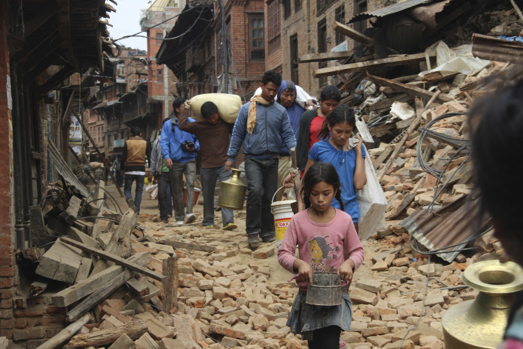 Earthquake survivors carry supplies through the streets of Kathmandu, Nepal. The United Methodist Committee on Relief and other members of ACT Alliance are organizing to provide assistance. Photo courtesy of ACT Alliance