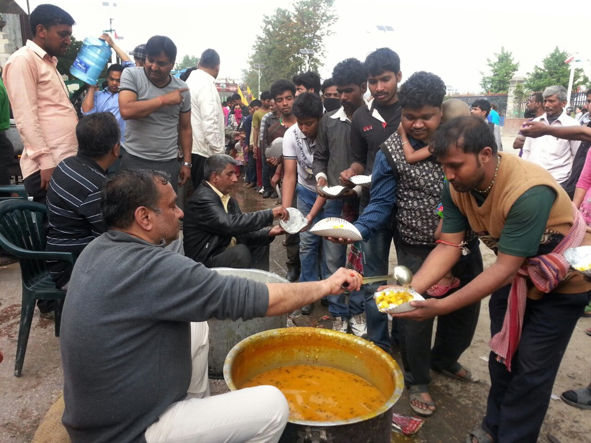 Community kitchens set up around Kathmandu to feed earthquake survivors. Here, volunteers from Marwari Sewa Samiti distribute cooked meals in the Tudikhel section, serving about 5,000 a day. Photo courtesy of ACT Alliance