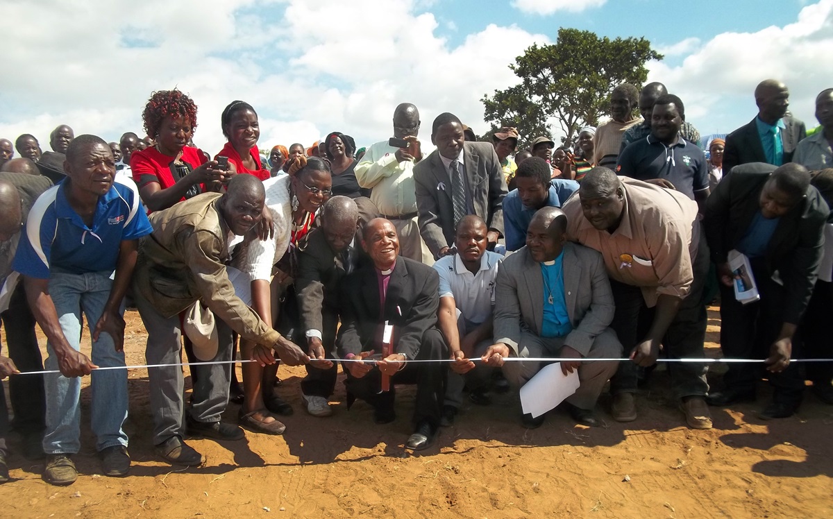 Bishop Eben K. Nhiwatiwa, Zimbabwe Episcopal Area, cuts the ribbon during the dedication of the Chitora-Gwarada Bridge in Zimbabwe. When the former bridge was destroyed by a cyclone in 2000 the community of nine villages had to travel  more than twice as far to reach the school and clinic.  Photo by Taurai Emmanuel Maforo
