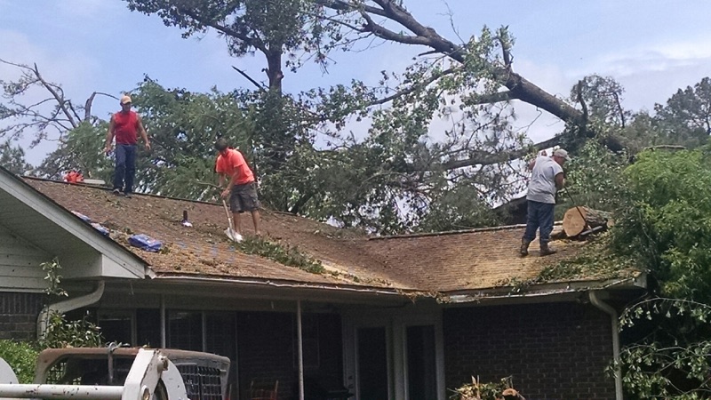 Volunteers begin clean up on the roof of a United Methodist Church parsonage in Nashville, Ark. Photo by Byron Mann, conference disaster response coordinator