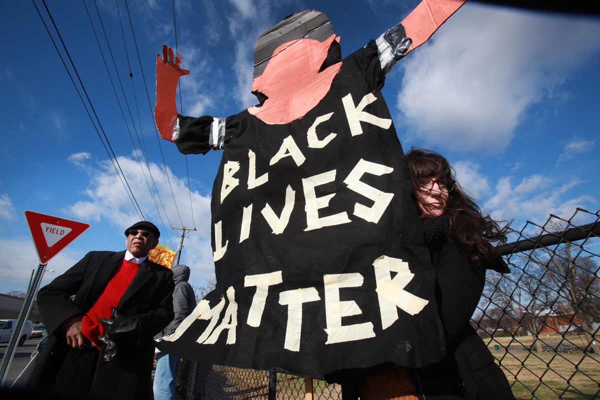 Marie Campbell, assistant director of education at Scarritt-Bennett Center, holds a sign reading, "Black Lives Matter." Demonstrators gathered on Dec. 9 in Nashville to show their support for racial justice and immigration reform.  The man to the left is AME minister, Edward Thompson, with NOAH. (Nashville Organized for Action & Hope). 