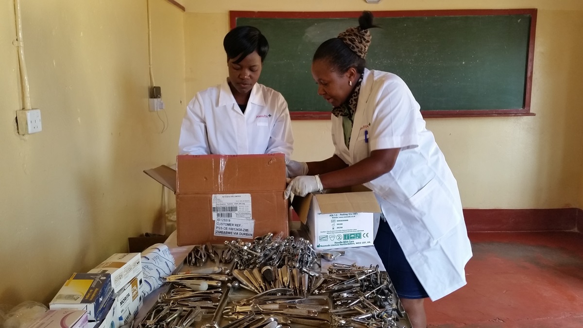 Dental Assistant Pretty Mazura and Dental Outreach Coordinator Sithulisiwe Moyo prepare equipment for the makeshift clinic. Oral examinations and treatment were offered to 80 clients during the cleanup day in Murombedzi, Zimbabwe. Photo by Eveline Chikwanah, UMNS