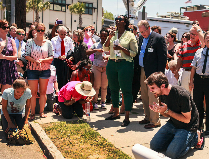 Mike Richards, a street pastor, invites people to kneel to pray and bless Charleston, S.C.  Photo by Lekisa Coleman-Smalls, UMNS