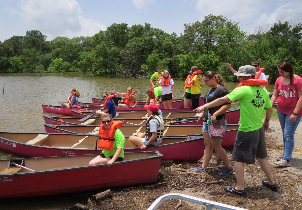 Rounding up enough canoes was one challenge in floating about 100 campers and staff to Cross Point United Methodist Camp in Kingston, Okla., on Monday, June 22. The camp is cut off from road access by recent floods. Photo courtesy Cross Point