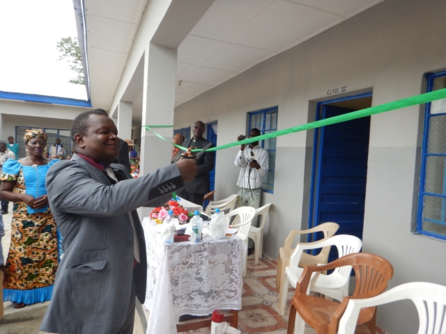 Leonard Ben Gbloh, Sierra Leone annual conference education secretary for primary schools, cuts tape as part of the dedication ceremony for the new school. 