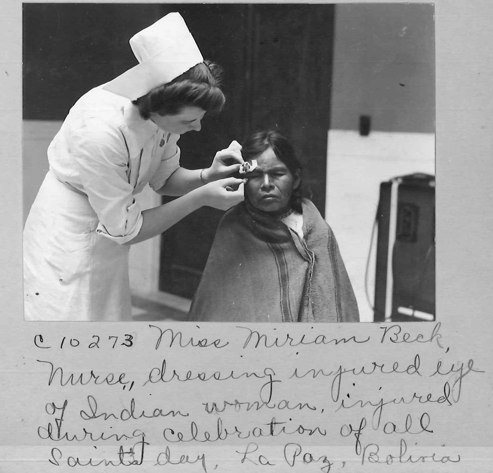 Handwritten captions provide interesting, but often incomplete, details on photos of Methodist mission activity. The caption here names a nurse treating a native woman in La Paz, Bolivia. 