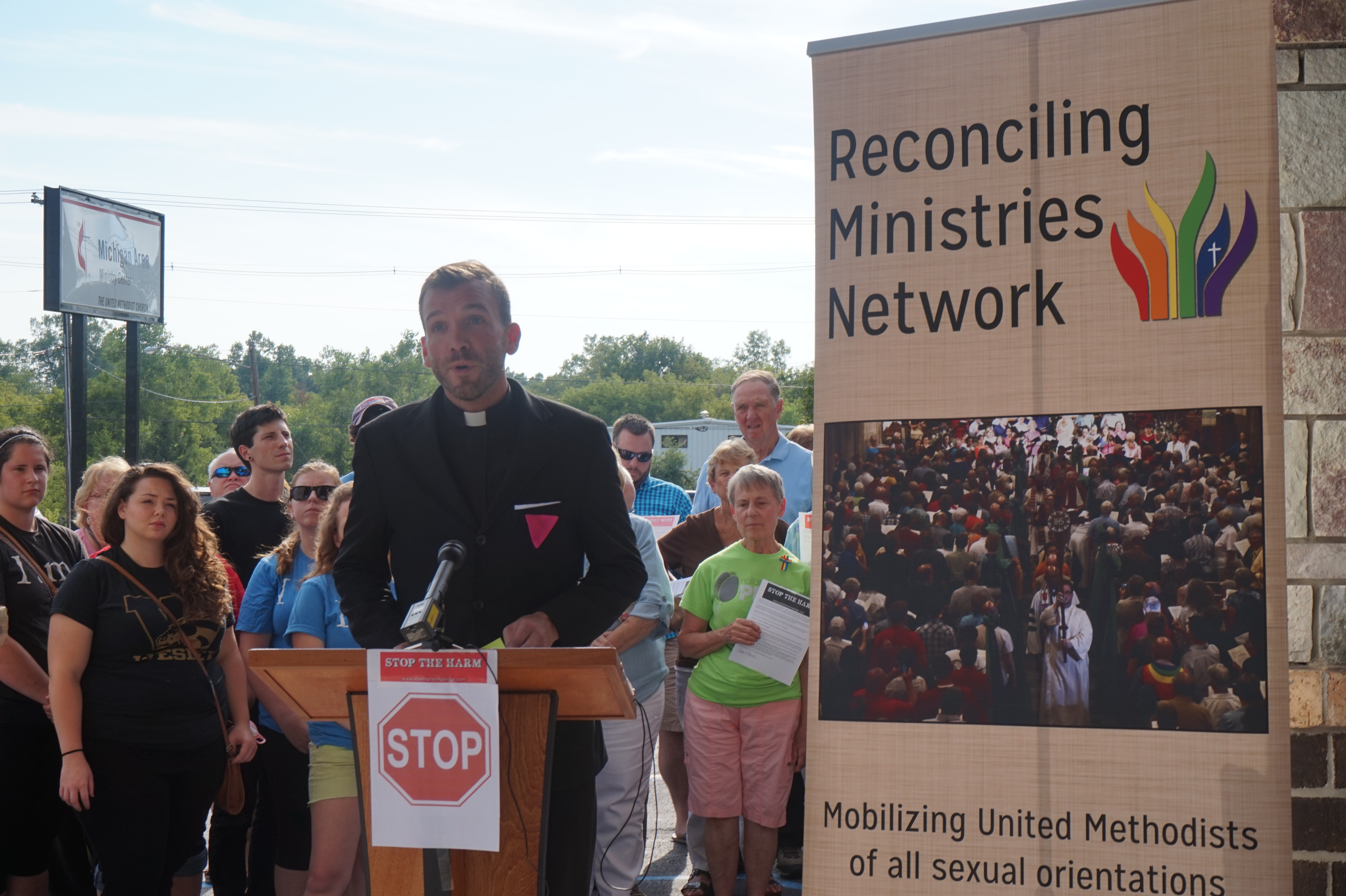 The Rev. Benjamin David Hutchison addresses supporters at a press conference July 28 outside the Michigan Area bishop’s office in Lansing, Mich. Hutchison, an African Methodist Episcopal pastor, was forced to resign July 13 from Cassopolis United Methodist Church after the district superintendent received a complaint that the pastor was openly gay and in a relationship. Photo courtesy of Reconciling Ministries Network