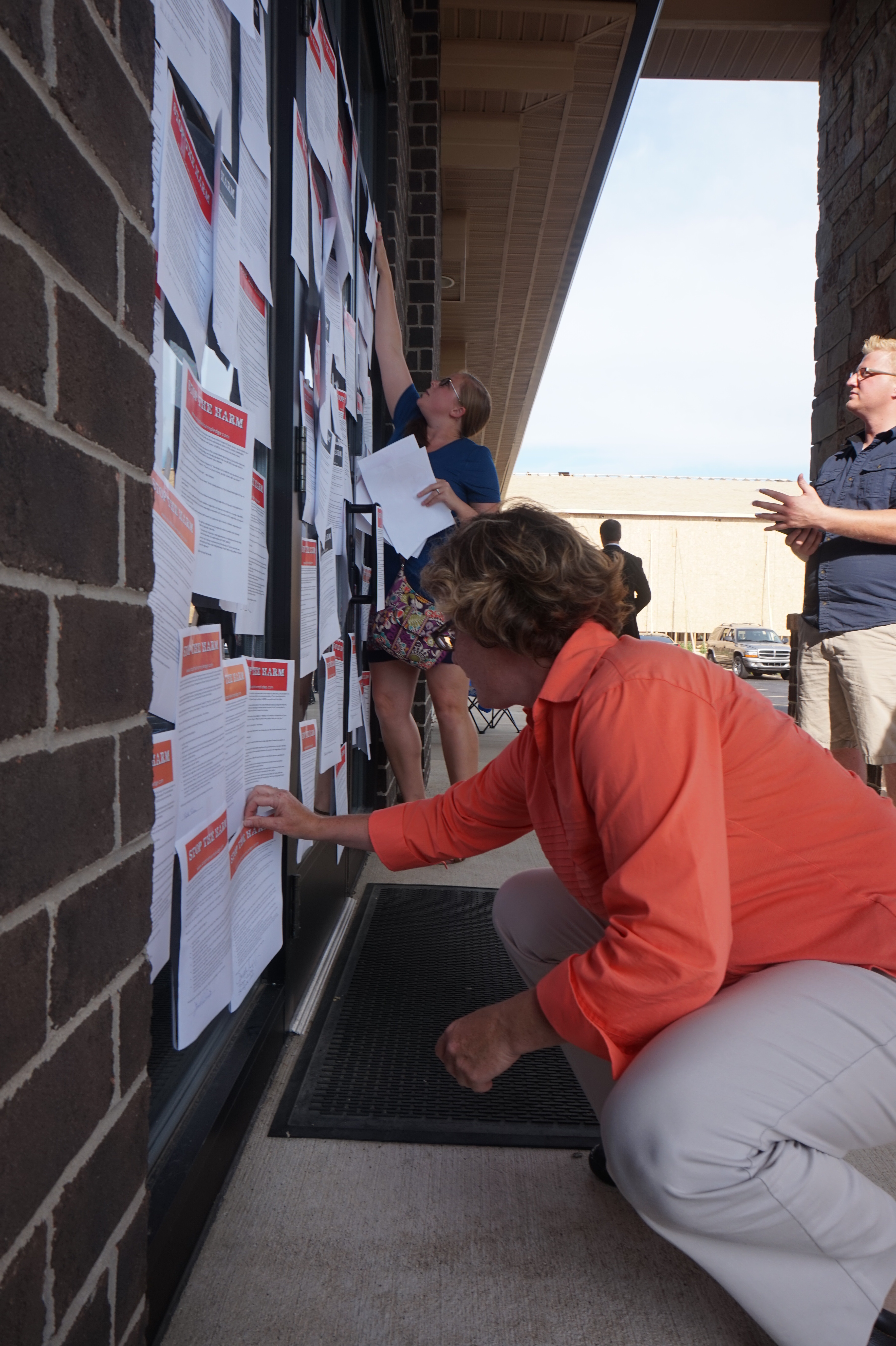 United Methodists post petitions to the office door of Michigan Area Bishop Deborah Lieder Kiesey, urging the denomination to “Stop the Harm” against lesbian, gay, bisexual, transgender and queer individuals. Photo courtesy of Reconciling Ministries Network
