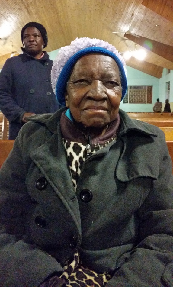 Eggester Jokomo sits inside St. Mark United Methodist Church in Harare, Zimbabwe following morning prayer.