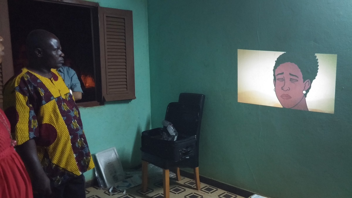 The Rev. Ezechiel Dadie watches the video animation “Ebola: A Poem for the Living” in Côte d'Ivoire. Photo by Neelley Hicks, United Methodist Communications