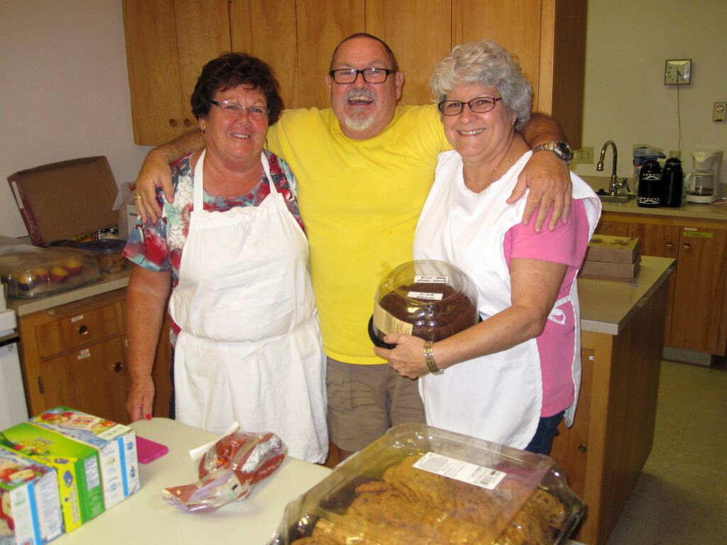 From left, Linda Robinson, Clint Baker and Nancy Baker are among the volunteers providing meals and shelter to residents finding refuge from wildfires at Pateros Community United Methodist Church in Washington. Photo by Jim Truitt