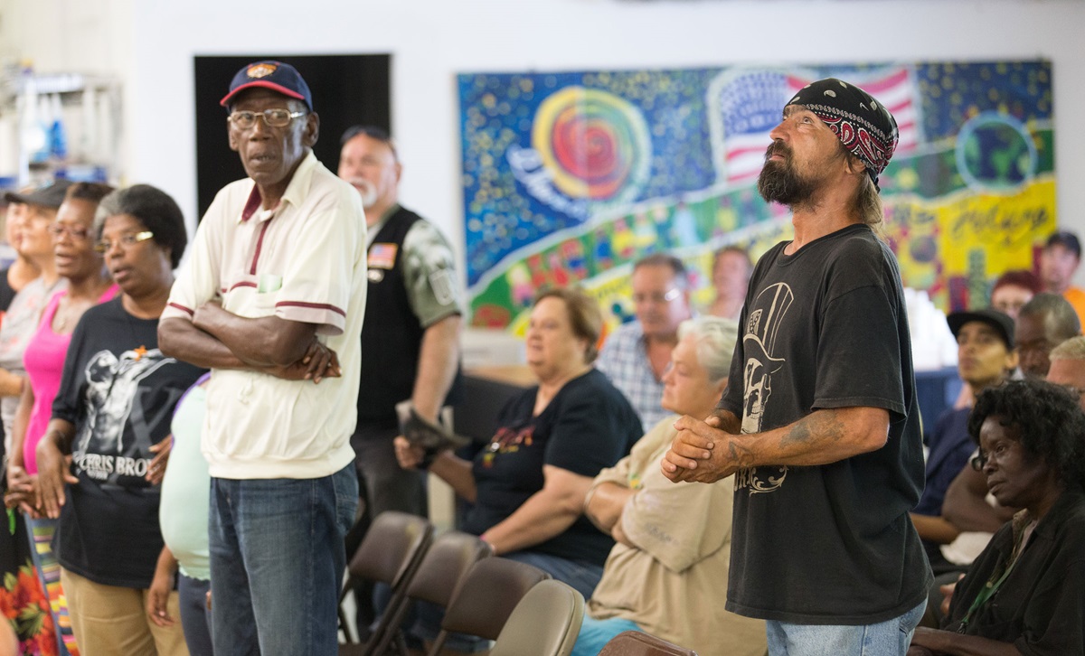 Earl Wollitt (right, foreground) casts his eyes upward during worship at Seashore Mission United Methodist Church in Biloxi, Miss. Photo by Mike DuBose, UMNS.