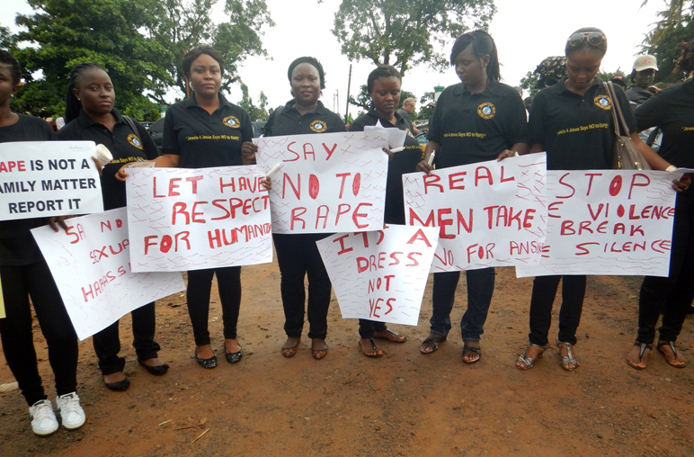 Hannah Bockarie’s grandfather, Rtd. Sgt. Maj. Joseph Foray Bockarie, joins the protest march against rape. Photo by Phileas Jusu, UMNS