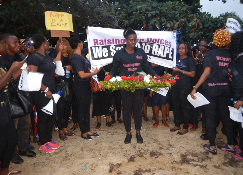 Women lay wreaths at the spot where Hannah Bockaire’s body was found on Lumley Beach in western Freetown, Sierra Leone.  United Methodists are among those protesting her brutal death and alleged gang rape. Photo by Phileas Jusu, UMNS