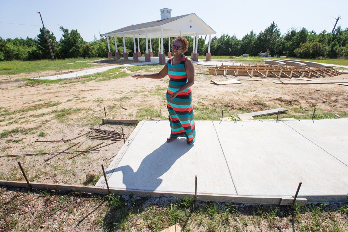 Dorothy Booker walks along the incomplete outdoor prayer pavilion at historic Gulfside Assembly in Waveland, Miss. Hurricane Katrina destroyed every building on the grounds in 2005. Photo by Mike DuBose, UMNS.