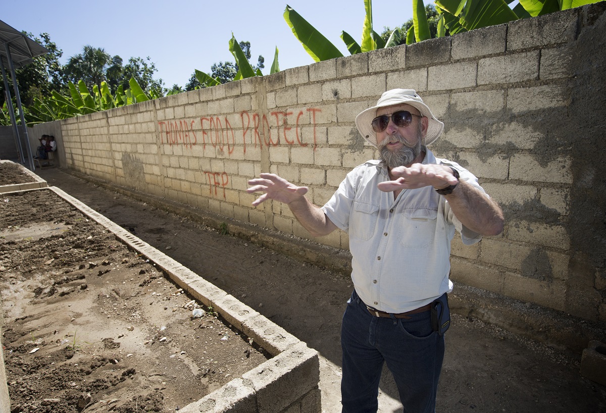 Warren McGuffin shows the raised-bed garden where okra has been planted at the Thomas Food Project in Thomas, Haiti. McGuffin is director of sustainability for the project. 2013 file photo by Mike DuBose, UMNS