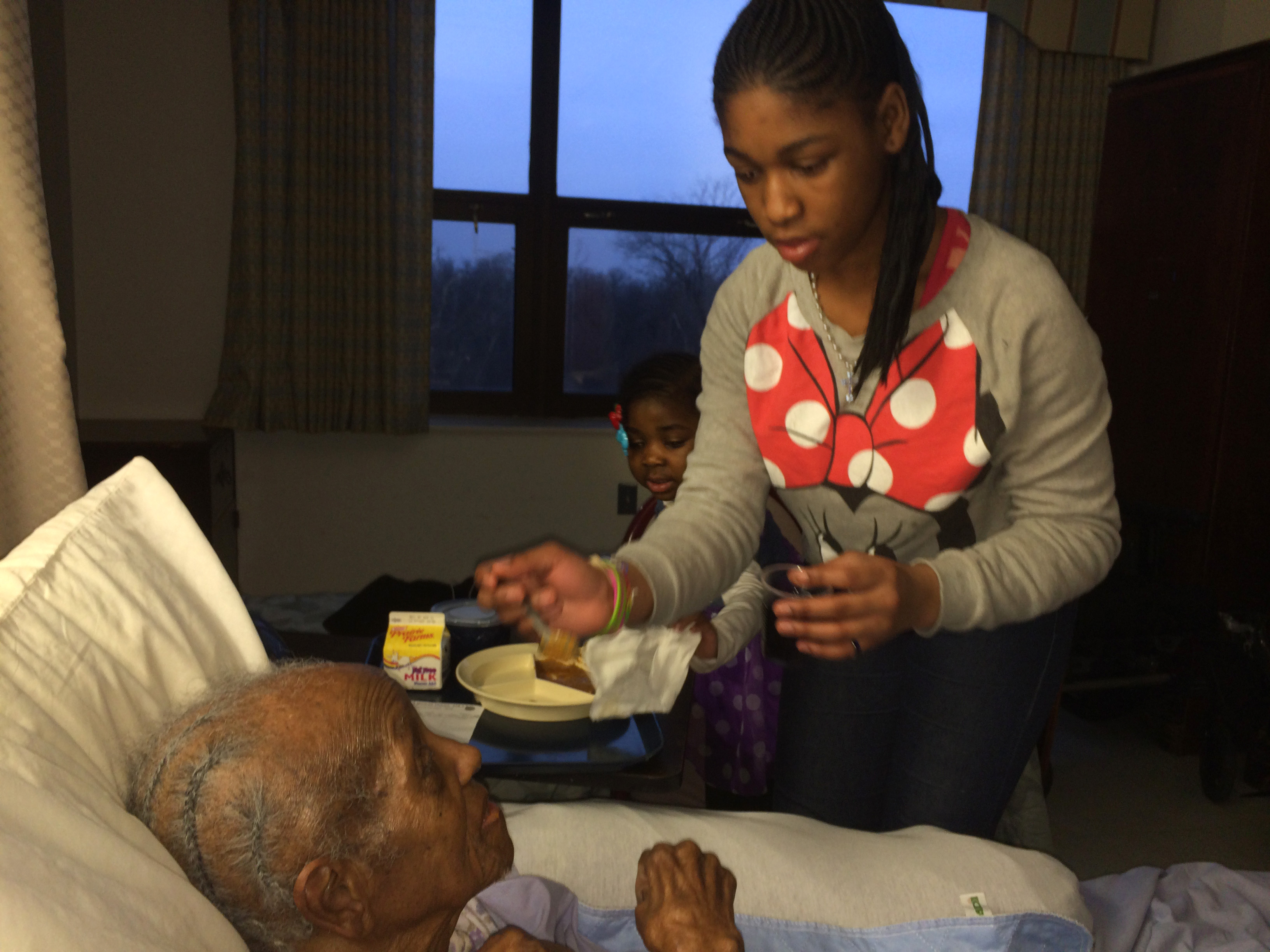 Erica, 14, feeds Mildred Tharpe, 101, the oldest member of Resurrection United Methodist Church in Chicago, during a recent visit. The Rev. Julie Fleurinor said she often takes the children with her on nursing home visits because the residents don't often get to see young children, and they enjoy visiting with them. 