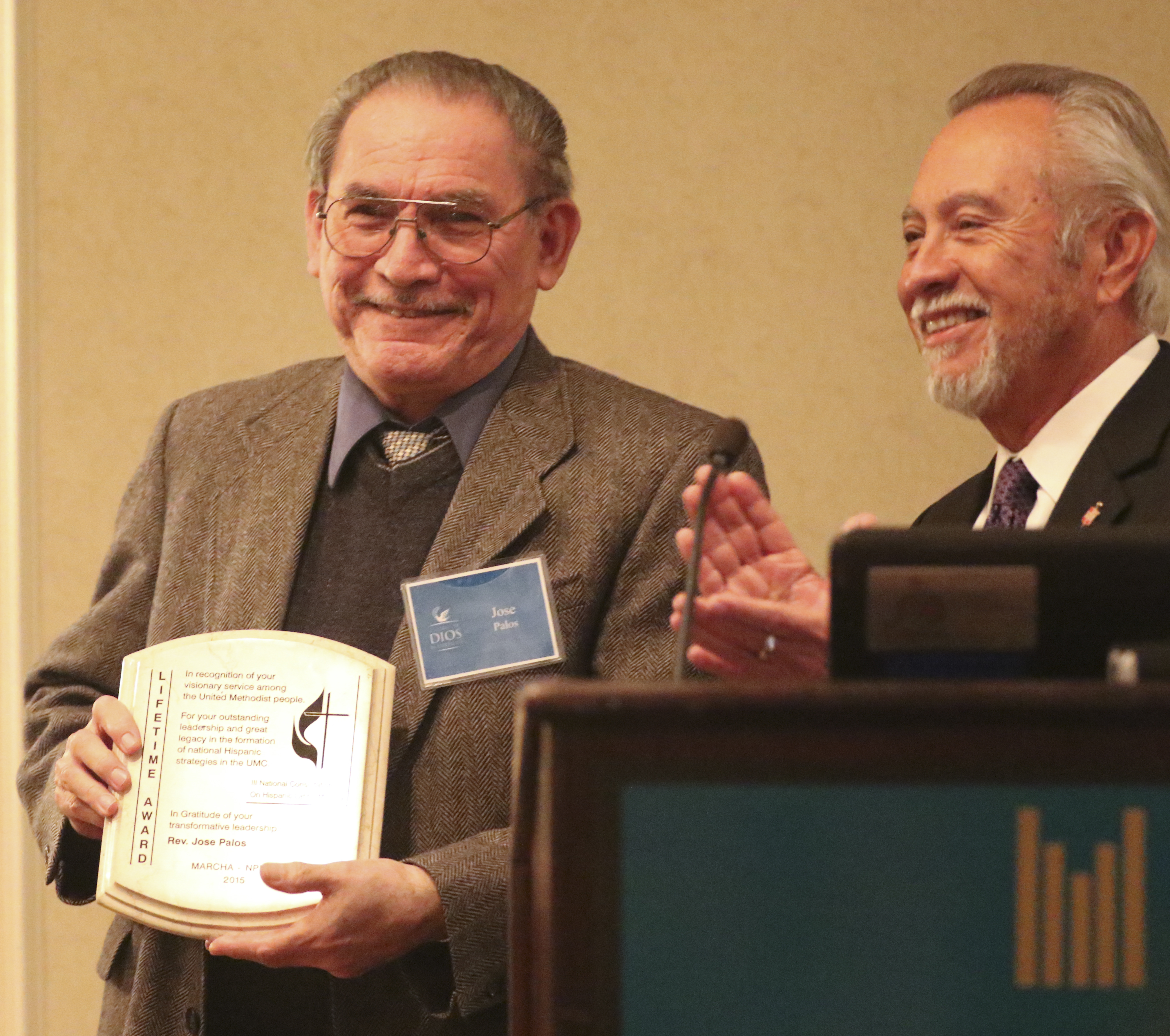  The Rev. JosÃ© Palos, founding director of the National plan receives a recognition award at the third National Consultation on Hispanic/Latino Ministry on March 12-14 at Duke Divinity. Presenting the award is Bishop Elias Galvan. Photo by Rev. Arthur McClanahan, Iowa Conference
