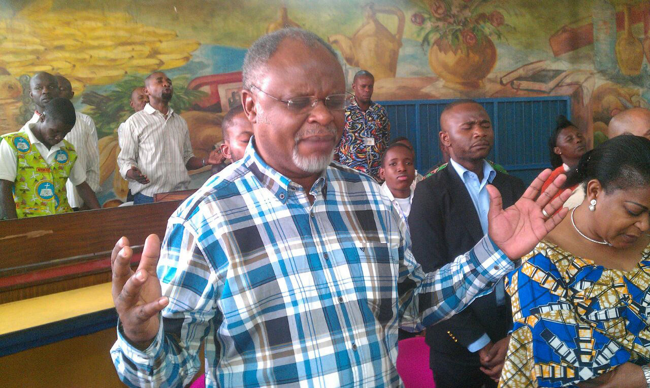 Vano Kalembe Kiboko, a United Methodist evangelist, prays in prison in the Democratic Republic of Congo. He has been helping to lead hundreds of people to Christ while in prison himself. Photo courtesy of Rev. Kiboko I. Kiboko