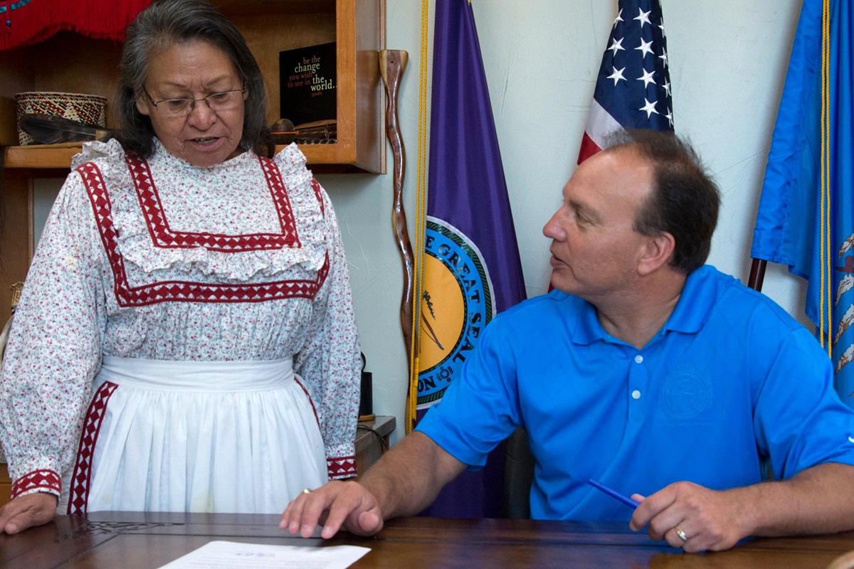 Chief Gary Batton of the Choctaw Nation signs a proclamation declaring the second Monday of October as “Indigenous Peoples’ Day.” Witnessing the signing is the Rev. Billie Nowabbi, a retired pastor in the Oklahoma Indian Missionary Conference. Photo courtesy of the Choctaw Nation of Oklahoma.  
