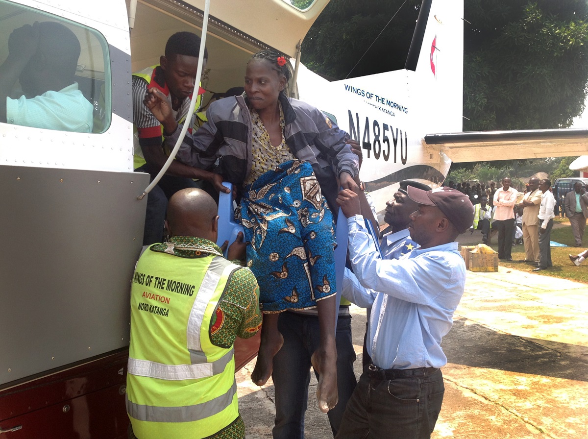 A Kamina woman who needs medical care is helped onto Wings of the Morning for a flight to Lumumbashi. Photo courtesy of Betty Kazadi Musau