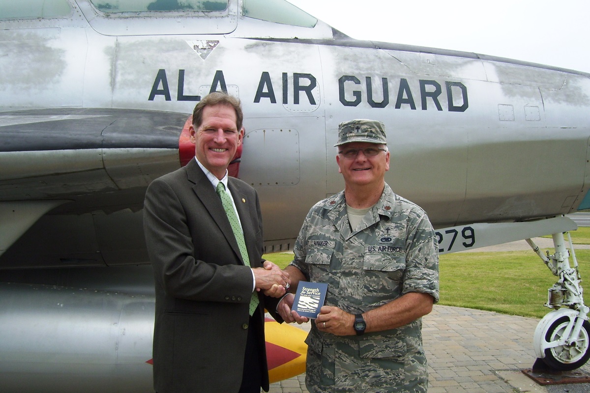 Larry Coppock (left), acting executive director of Strength for Service and a staff member of the General Commission on United Methodist Men, presents a copy of “Strength for Service to God and Country” to Maj. Daryl R. Hamaker, chaplain of the 117th Air Refueling Wing in Birmingham, Ala. Photo courtesy of United Methodist Men

