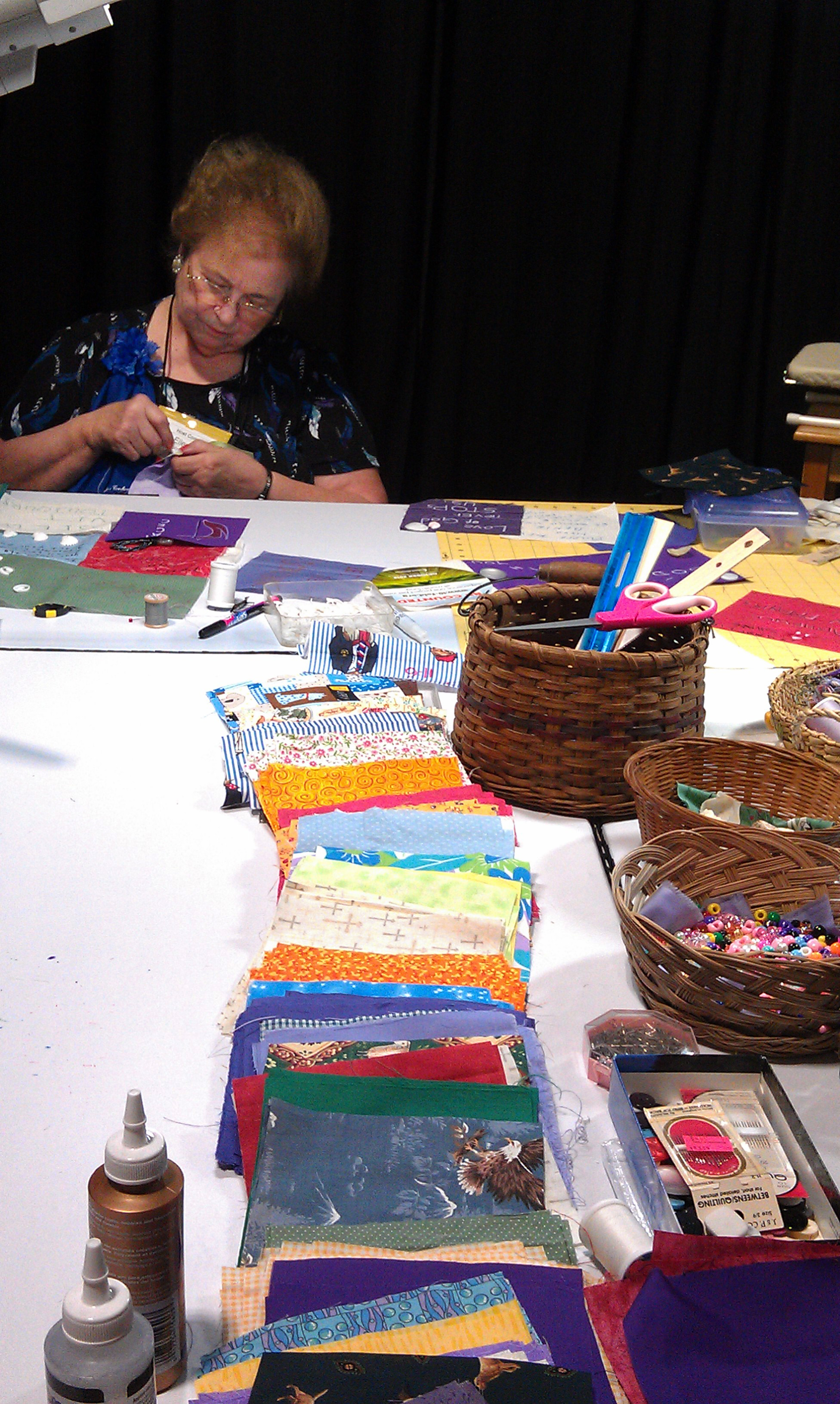 Ellen Johnsen works on a quilt square for a larger quilt from the collective squares decorated by participants at the 2012 General Conference in Tampa, Fla. Photo by Leigh Rogers, UMW