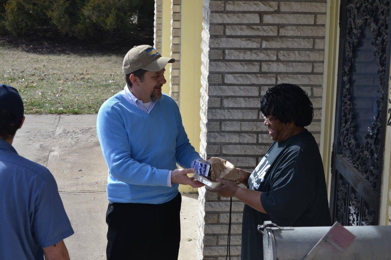 The Rev. Mark Holland joins a Meals on Wheels route in Kansas City, Kansas. He’s pastor of Trinity Community Church, a United Methodist congregation, as well as mayor of Kansas City, Kansas. Photo courtesy Mark Holland