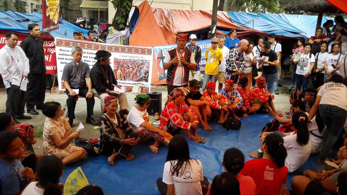 During Lumad Solidarity Day, Datu Dulphing Ogan (standing) expresses his gratitude. Datu means chief. Seated, third from the left, is the Rev. Joey Umali with other United Methodist leaders and the Lumad people. A UMNS photo courtesy of Noel Vincent P. Miguel.