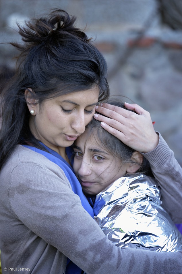 Zoya Hameed (left), a physician from the United Kingdom, hugs Hanin, a frightened Syrian refugee girl, on a beach near Molyvos, on the Greek island of Lesbos, on Oct 30,. 2015. The girl was on a boat full of refugees that traveled to Lesbos from Turkey. Hameed is one of hundreds of volunteers on the island who receive the refugees and provide them with warm clothing and medical care before they continue their journey toward western Europe. 