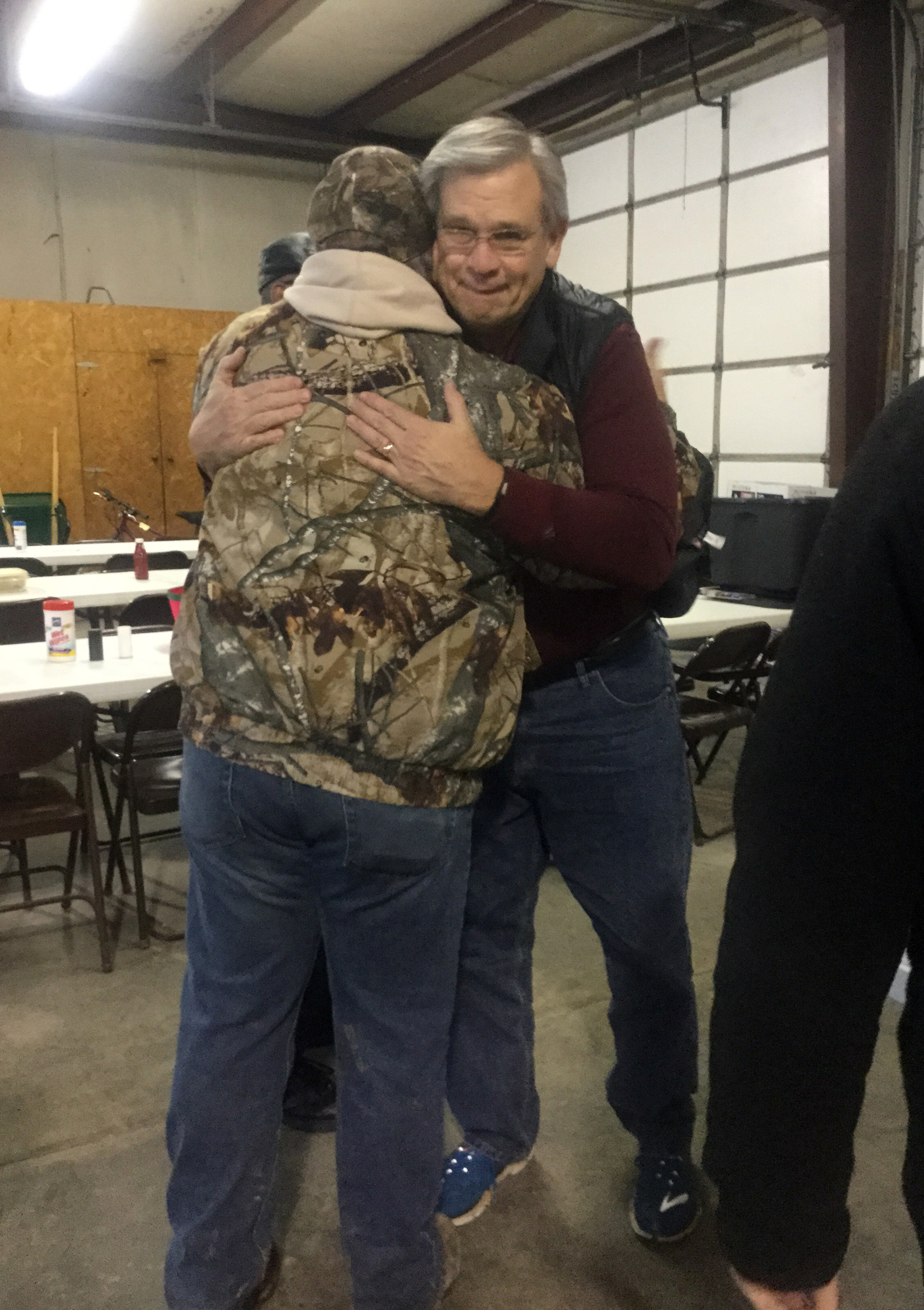 Bishop Bill McAlilly hugs the Rev. Tommy Flood from Lutts United Methodist Church in Lutts, Tenn.  Photo by Abigail Overstreet