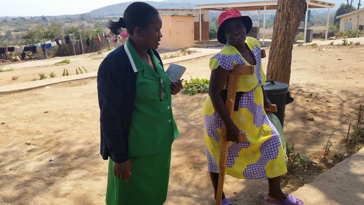 Acting matron Mtokoma chats with Stella Mabhogo who was making her way to the main hospital complex for a meal. Photo by Eveline Chikwanah, UMNS