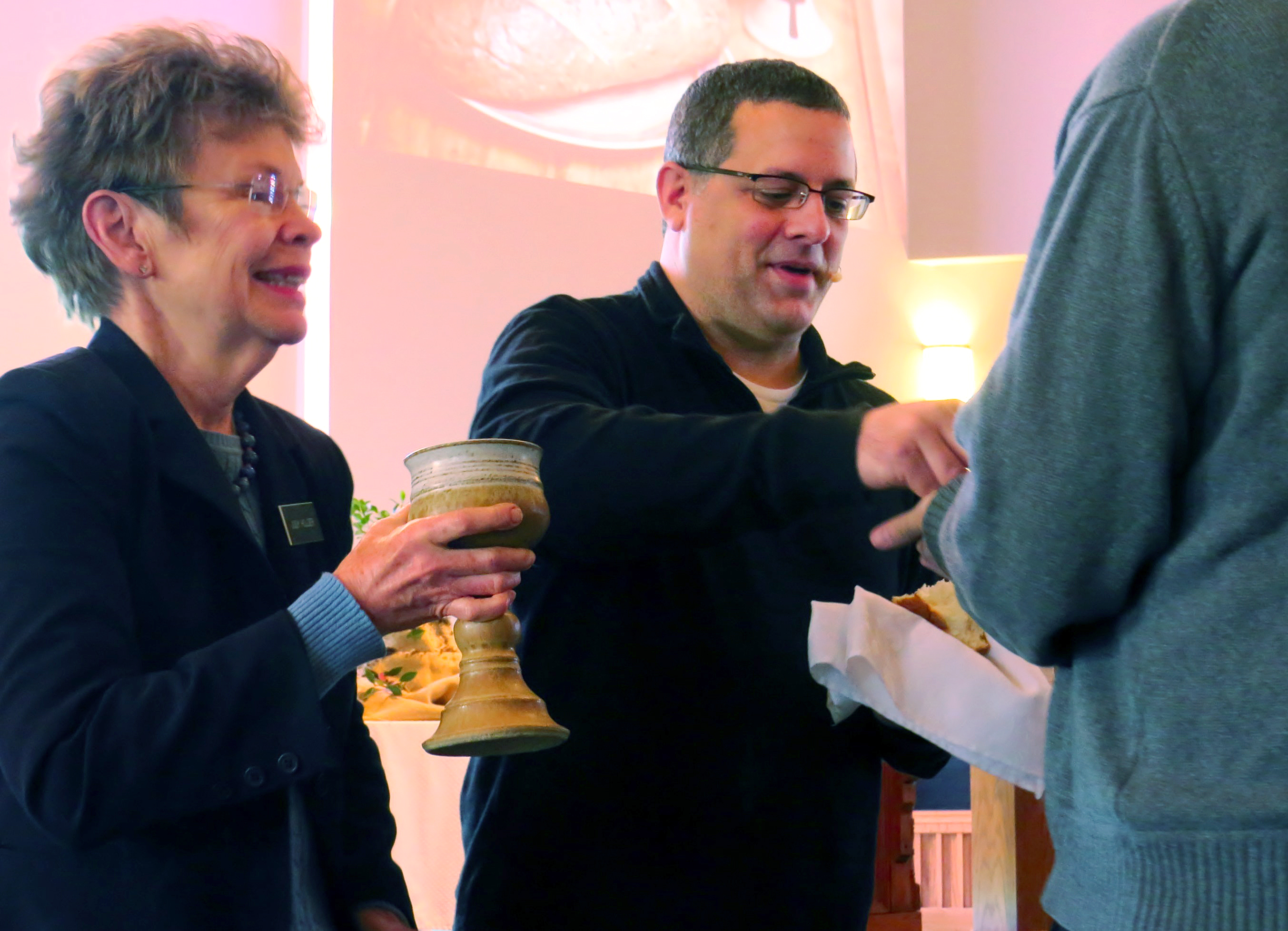 The Rev. Omar Rikabi offers communion on Jan. 17 at First United Methodist Church in Heath, Texas. UMNS photo by Sam Hodges