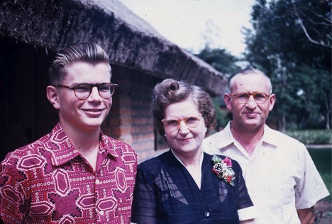 1955 Bill Lovell and his Mother and Father Eloise and Marshall Lovell standing in front of their home at Wembo Nyama. Photo courtesy of Bill Lovell