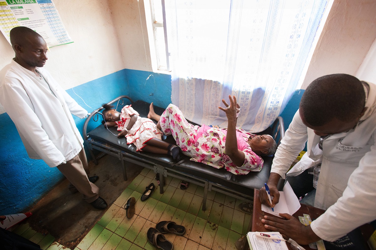 Gael Nonge (left, on bed) shares a hospital bed with Margelitte Enanga at The United Methodist Church's Irambo Health Center in Bukavu, Democratic Republic of Congo. The two patients are not related. There were not enough beds for each to have her own. 