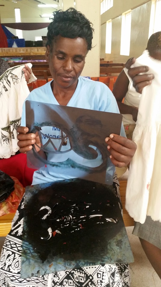 Emilia Mafuratidze holds an X-ray film that she is recycling as a stencil to print fabric during a workshop  in Zimbabwe held by the Chitungwiza-Marondera District women’s union March 1-3, 2016. Photo by Eveline Chikwanah, UMNS 
