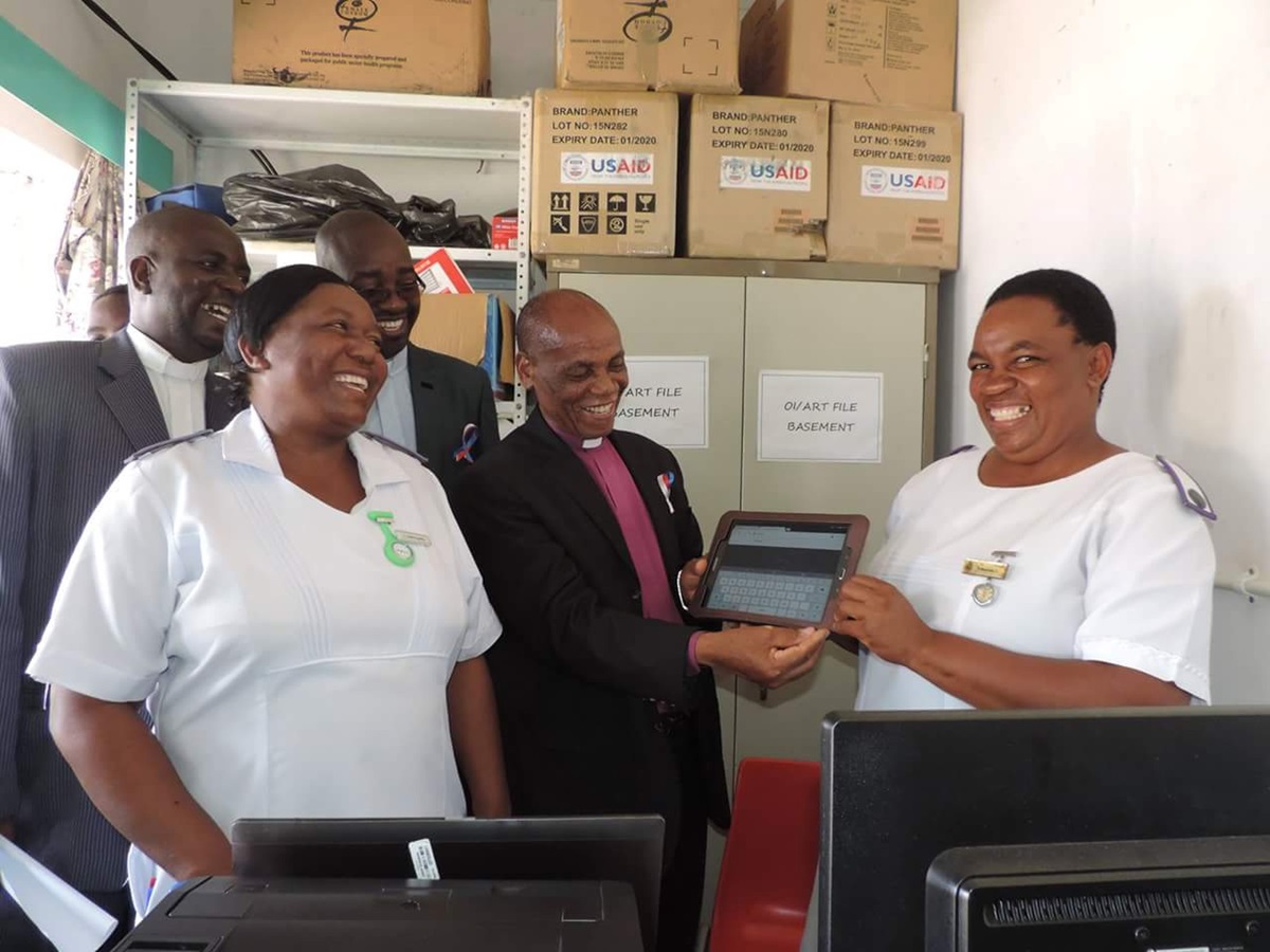 The computerization of this rural health facility impresses Bishop Eben Kanukayi Nhiwatiwa. Photo by Taurai Emmanuel Maforo, UMNS