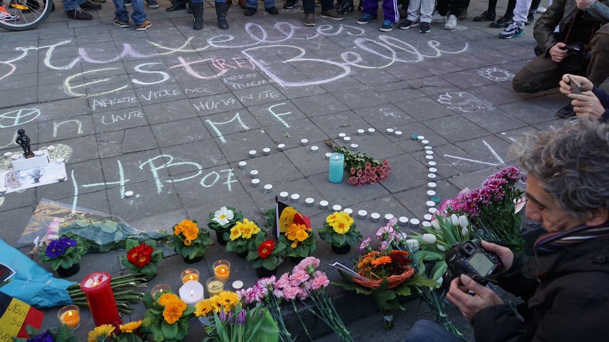 People gather at a memorial in Brussels for those killed and injured in Tuesday's terrorist attacks. Photo by Miguel Discart, Wikimedia Commons