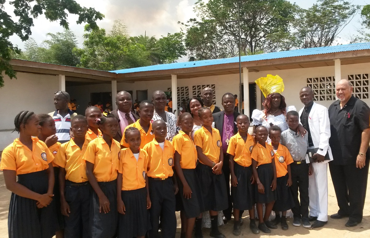 Members of leadership of The United Methodist Church in Liberia stand with students of the Eric Scott Memorial United Methodist School in Bopolu City, Gbarpolu, Liberia. 