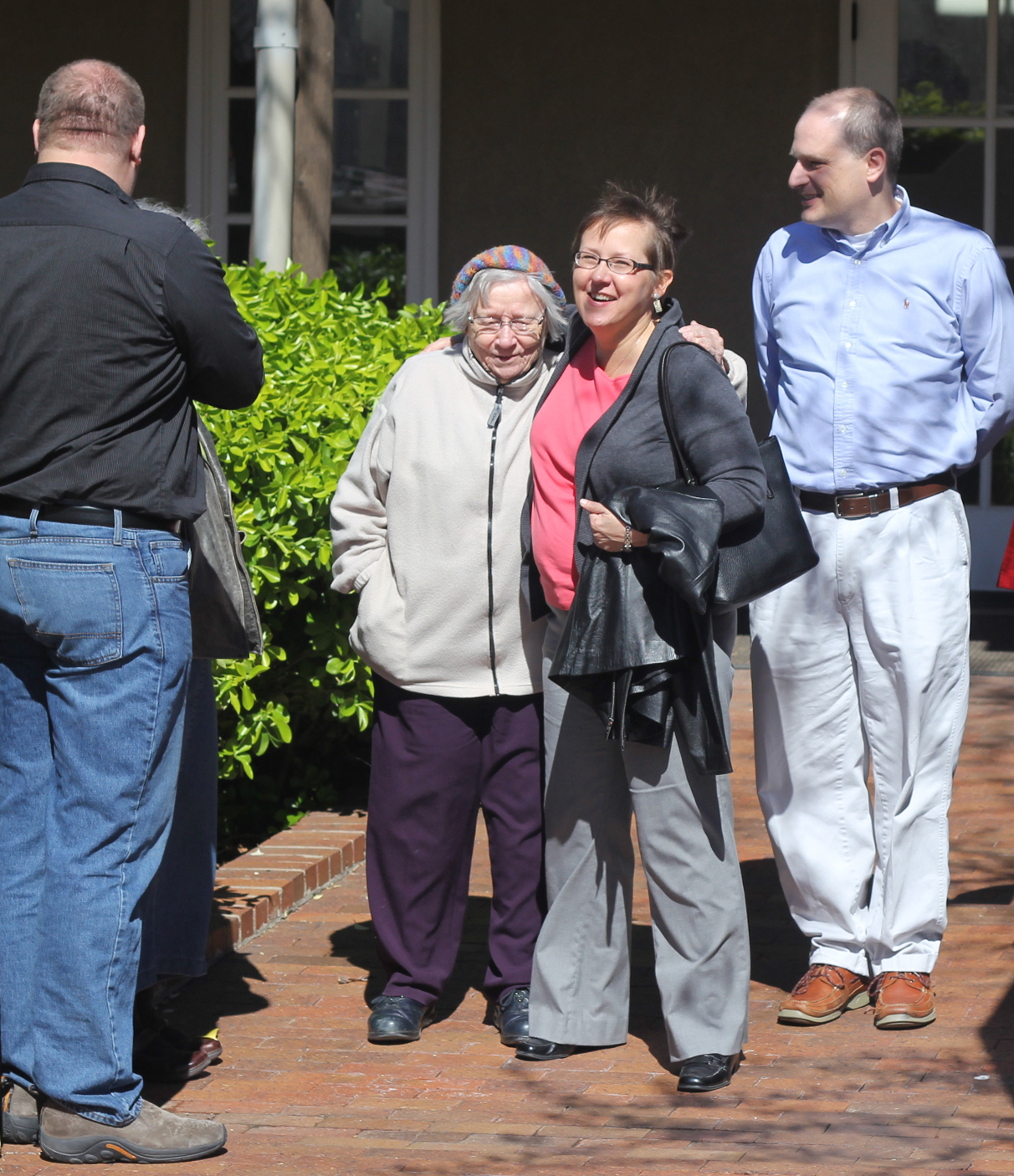 The Rev. Cynthia Meyer (second from right) gets a hug and well wishes from supporters after a meeting with United Methodist Bishop Scott Jones March 28 in Wichita, Kan. Meyer faces church disciplinary charges after she announced she was in a “committed relationship” with another woman. 