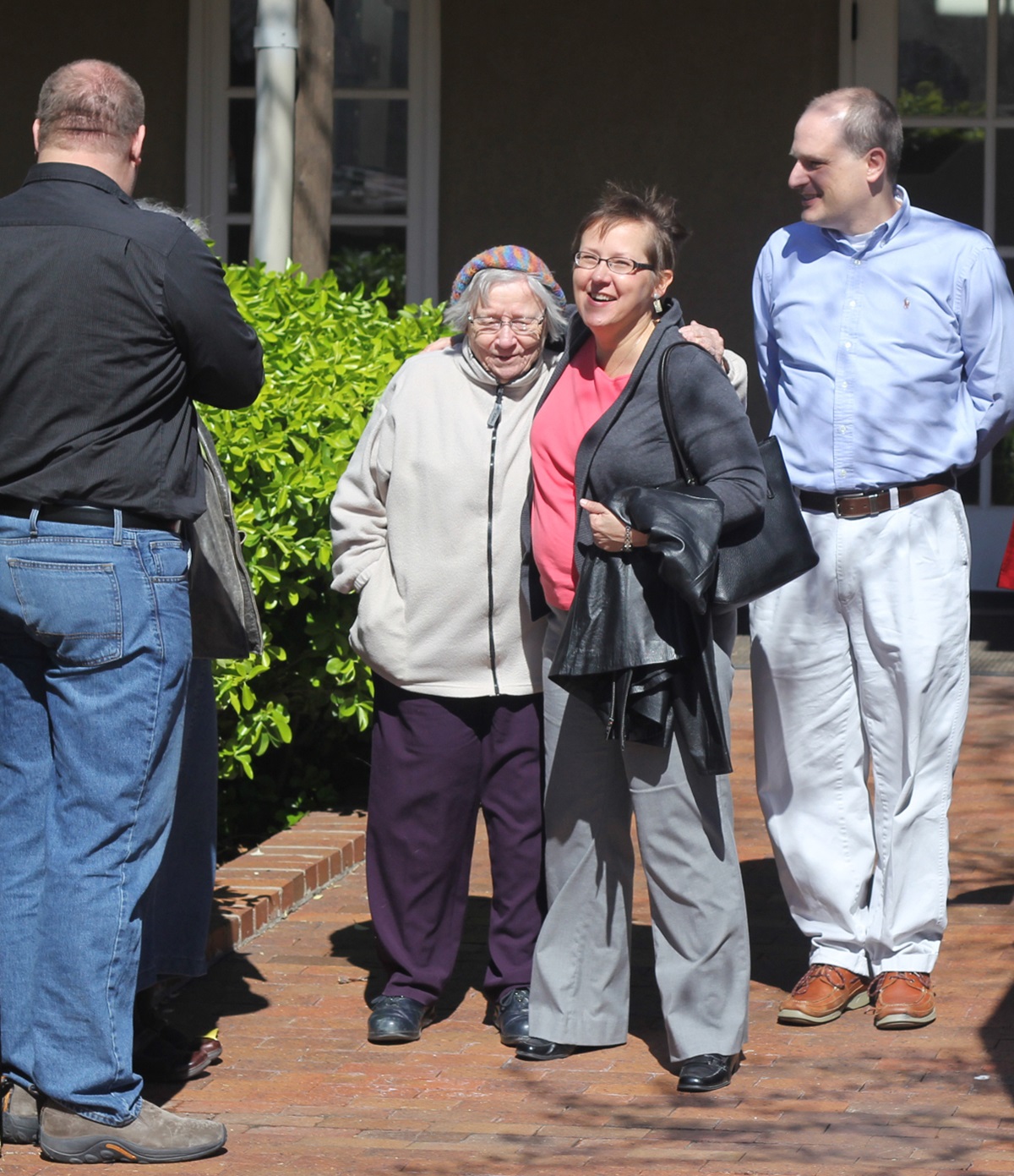 The Rev. Cynthia Meyer (second from right) gets a hug and well wishes from supporters after a meeting with United Methodist Bishop Scott Jones March 28 in Wichita, Kan. Meyer faces church disciplinary charges after she announced she was in a “committed relationship” with another woman. 