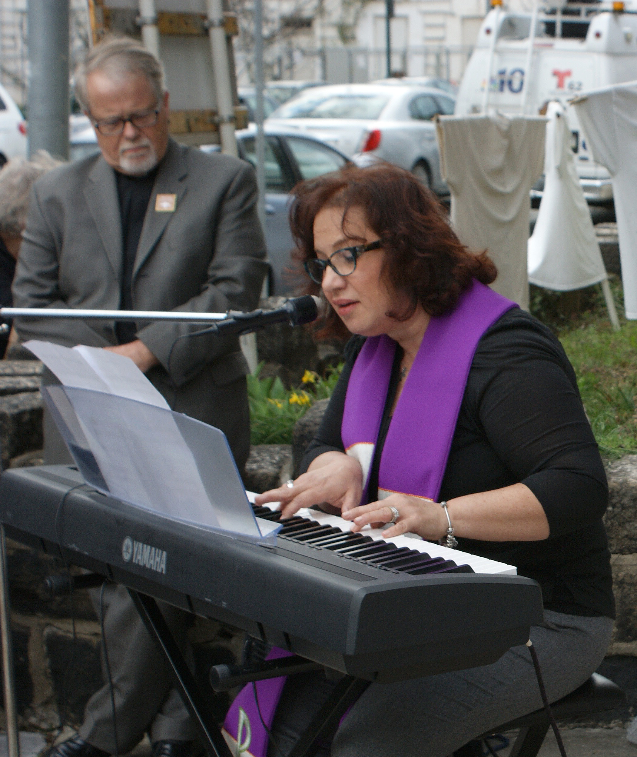 United Methodist pastors the Revs. Lydia Munoz and James McIntire lead the assembled in songs of grief for the lost, faith in God and inspiration. Photo by the Rev. Linda Noonan