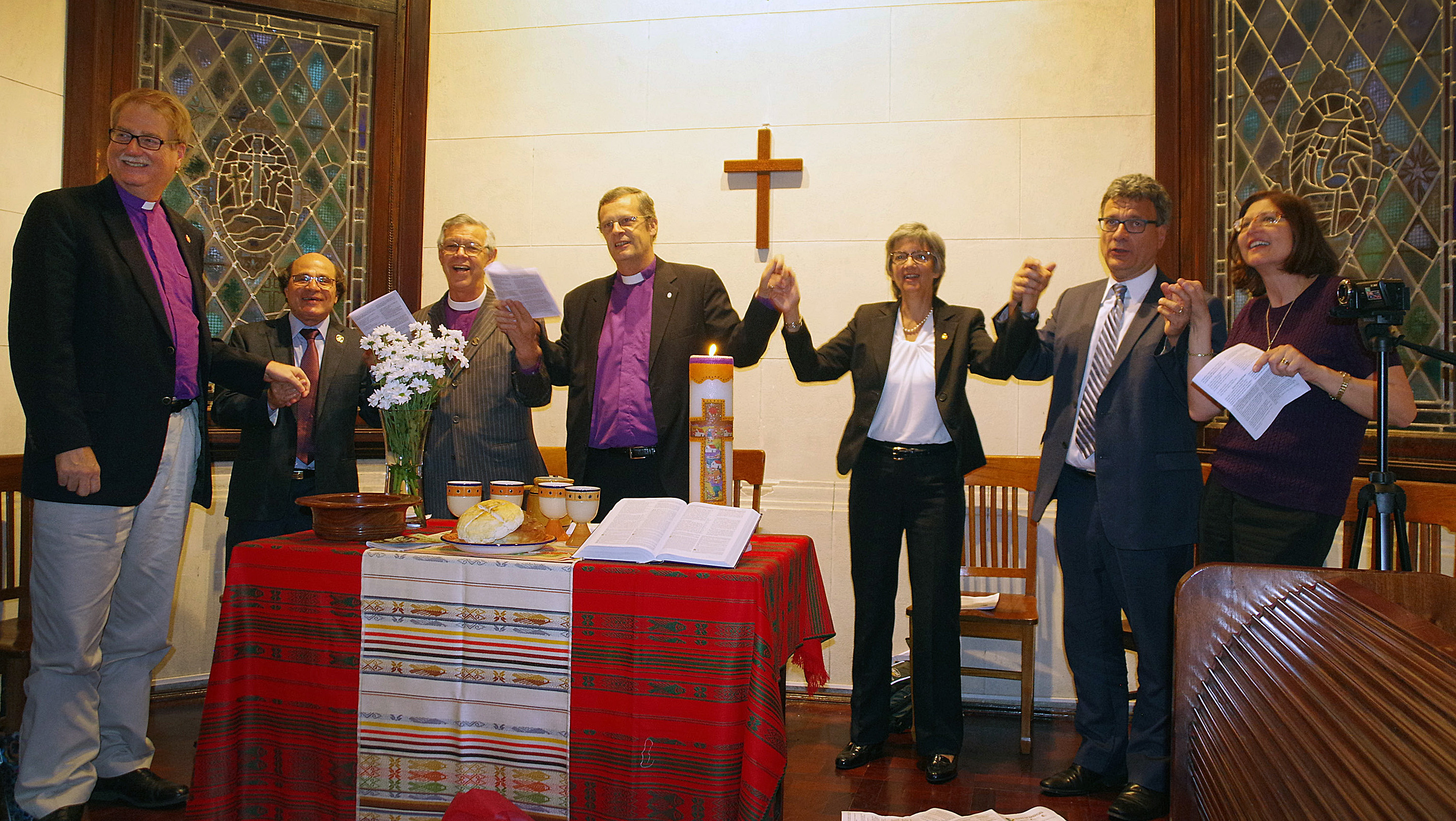 The opening of the United Methodist Global Ministries and Upper Room regional office in Bueno Aires, Argentina, is celebrated with song. (From left) Bishop Ken Carter (United Methodist Church), Bishop Adriel de Souza Maia (Brazilian Upper Room), Bishop Stanley S Moraes (Methodist Church of Brazil), Bishop Frank de Nully Brown (Argentinian Evangelical Methodist Church), Bishop Hope Morgan Ward (President of Global Ministries), Thomas Kemper (top executive of Global Ministries) and Sarah Wilke (Upper Room). Photo by Gustavo Vasquez, UMNS