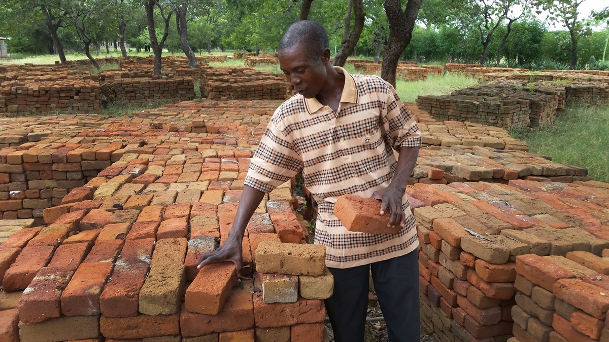 Hamadziripi Nyakudanga is satisfied with the quality of the 60 0000 bricks provided by the community for expanding and upgrading Dendera Clinic. Photo by Eveline Chikwanah, UMNS