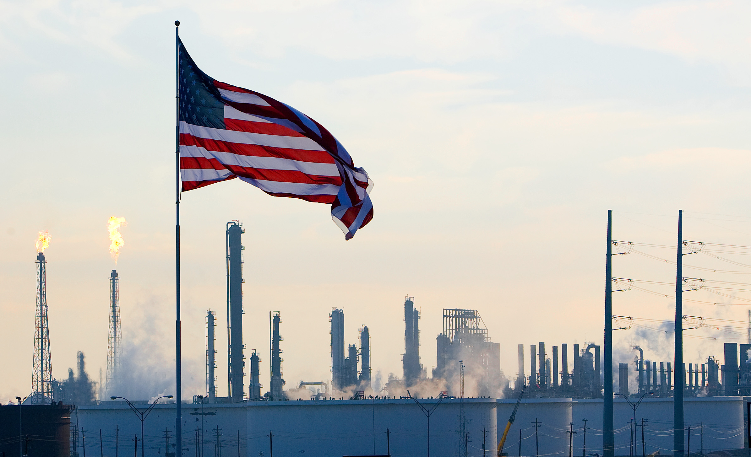 A U.S. flag flies above an oil refinery near Houston in 2008. Some United Methodists are calling for divestment from the fossil fuel industry. File photo by Mike DuBose, UMNS