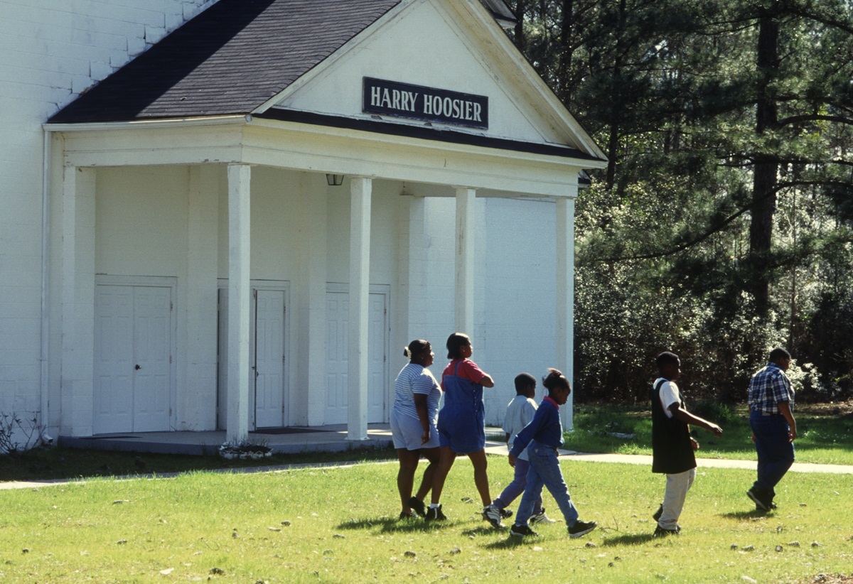 Children walk past Harry Hoosier Hall at Gulfside Assembly in Waveland, Miss., in 1997. 